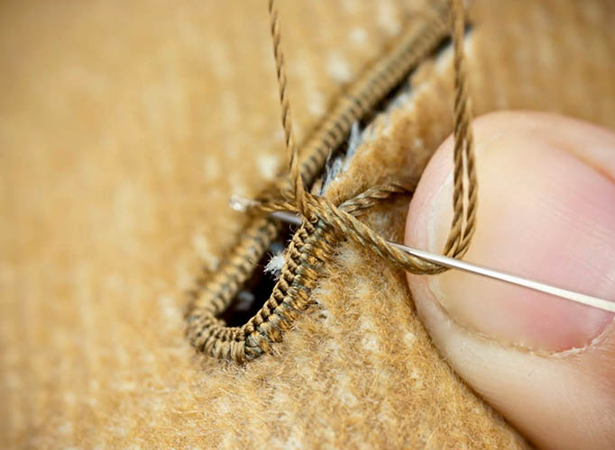 So machen Sie von Hand ein Knopfloch mit Faden und Nadel
